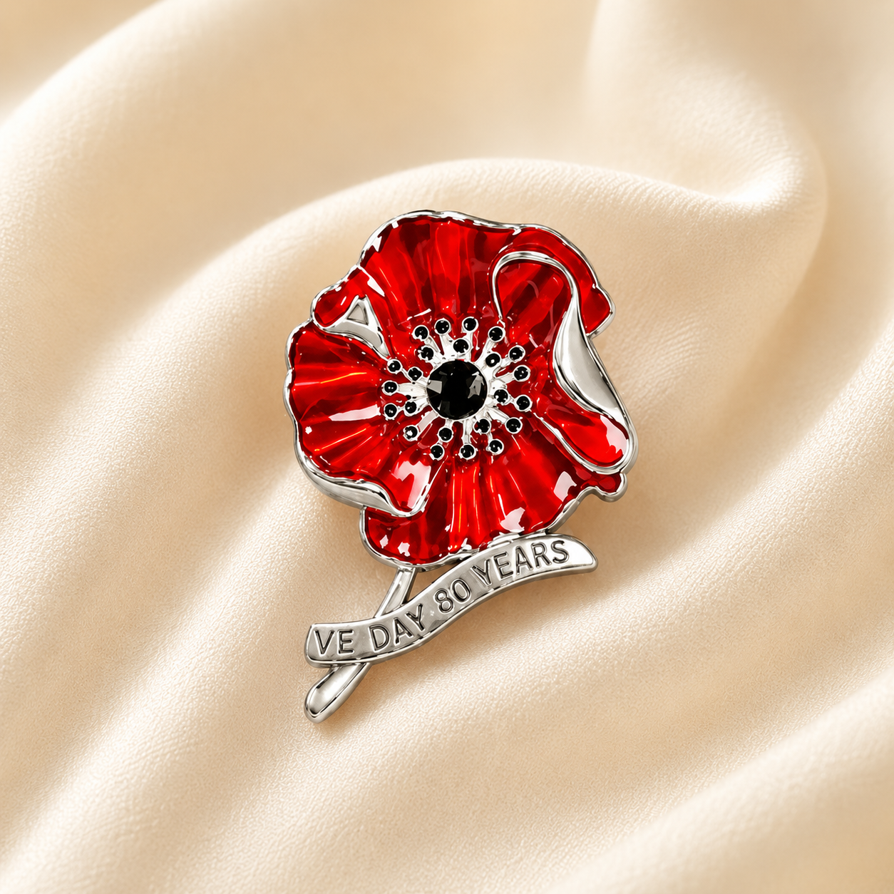 VE Day poppy brooch displayed on soft fabric
