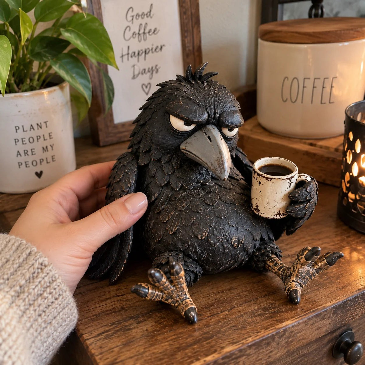 Hand beside the raven figurine to provide a visual sense of scale