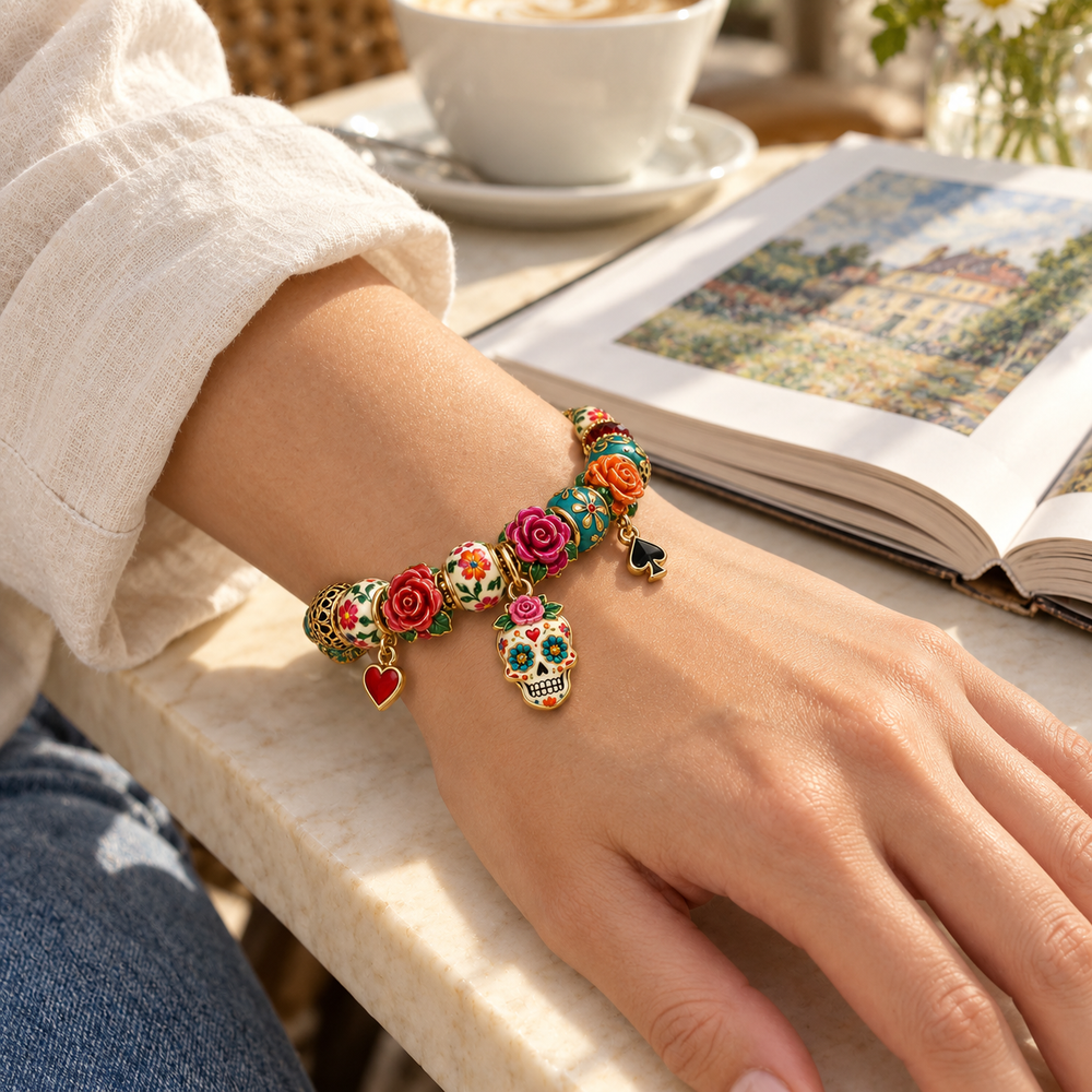 Turquoise Rose Charm bracelet styled on a wrist at a cafe table